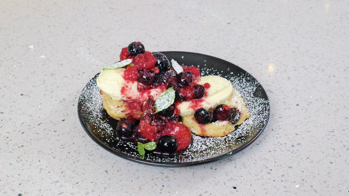 Berry compote with fruit scones and cream